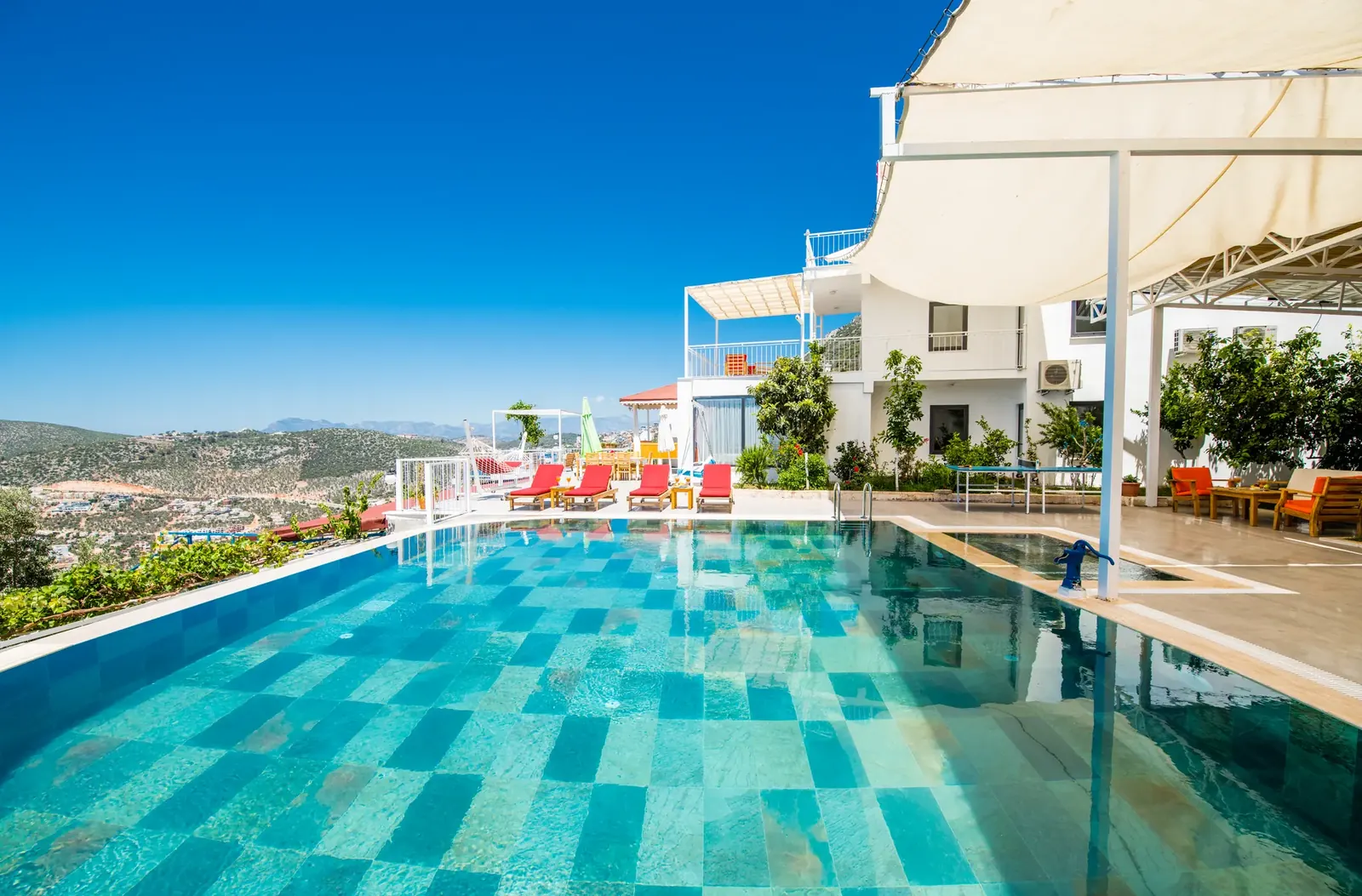 Deneme Villa exterior with infinity pool and hillside view in Kaş